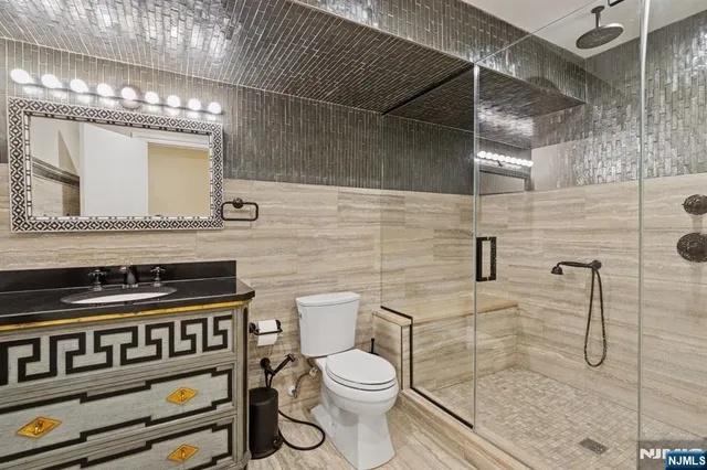 a bathroom with a toilet a sink and mirror