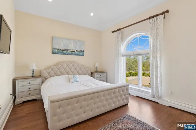 a bedroom with a large bed and a window