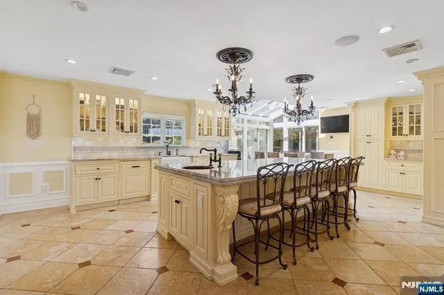 a kitchen with cabinets and chairs