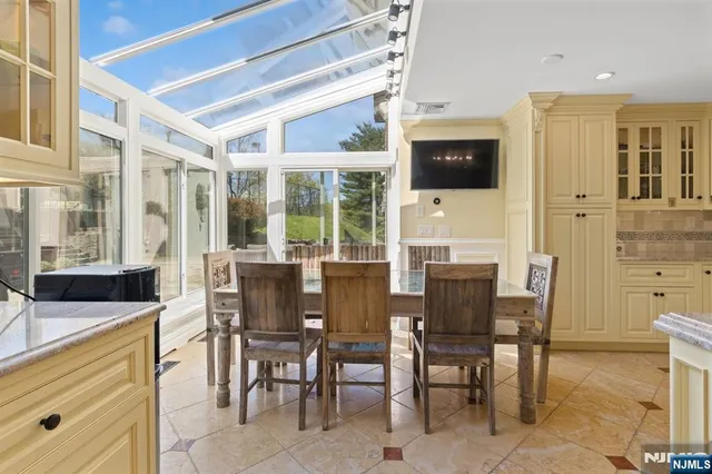 a dining room with furniture and large window