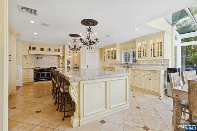a kitchen with cabinets and chairs