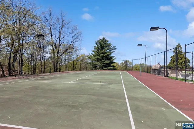 a view of backyard with outdoor seating and trees