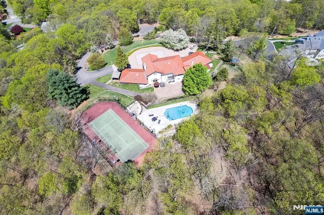 an aerial view of a house with a yard and lake view