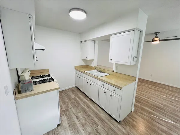 a kitchen with white cabinets and white appliances