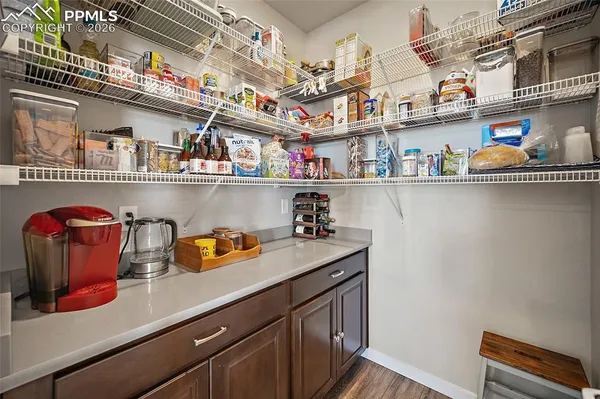 a utility room with lots of clutter and cabinets