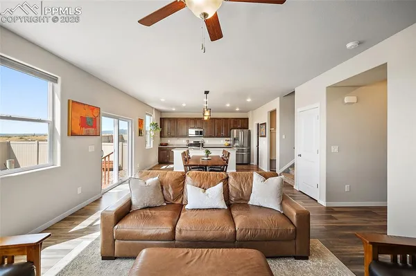a living room with furniture and a chandelier