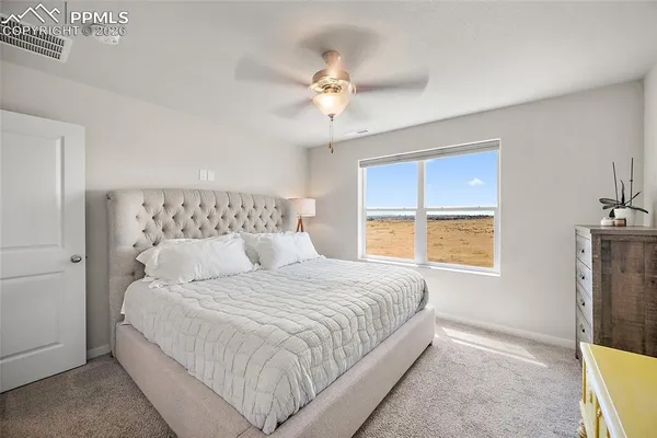 a bedroom with a large bed and a window