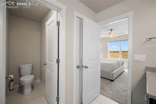 a bathroom with a toilet sink tub and mirror