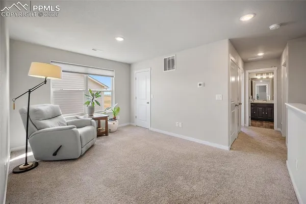 a view of a livingroom with furniture and a window