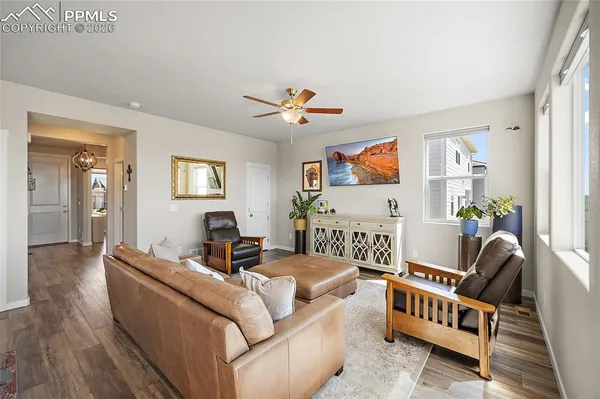 a living room with furniture and a wooden floor