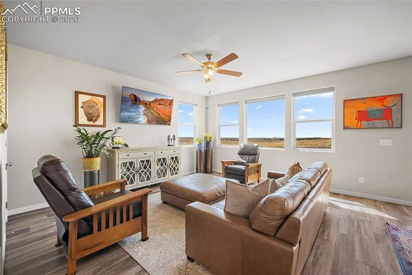 a living room with furniture and wooden floor