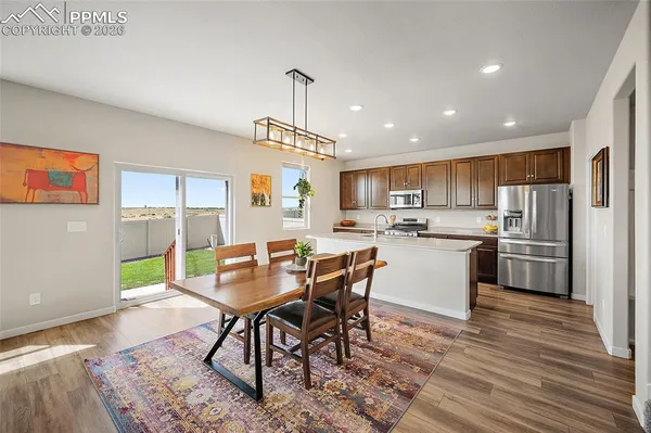 a view of a dining room with furniture window and wooden floor