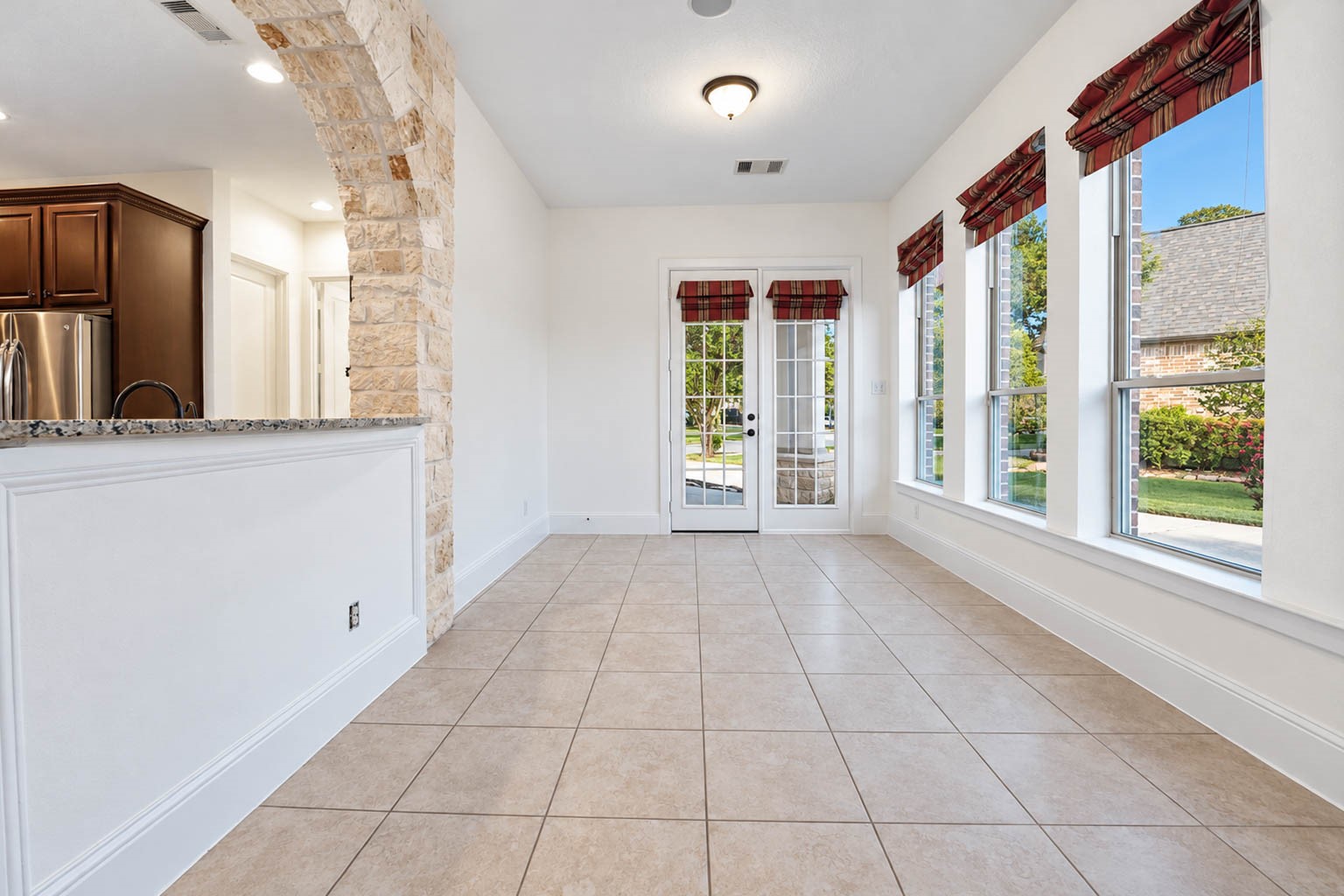 5403 Mesquite Ridge Street Fulshear, TX 77441 - Photo 18 of 42 Flexible and full of possibilities, this sunroom has the space for a game table, a cozy lounge area, or whatever suits your lifestyle. A row of tall windows brings in the daylight.