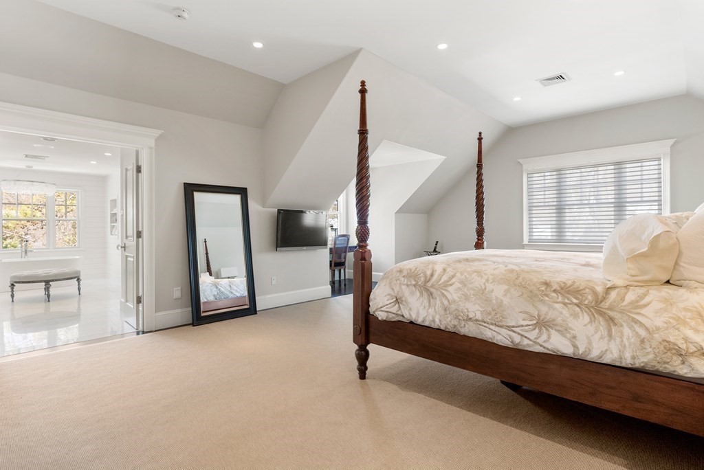 178 Lowell Road Wellesley, MA 02481 - Photo 22 of 38 a bed sitting in a spacious bedroom next to a window and closet