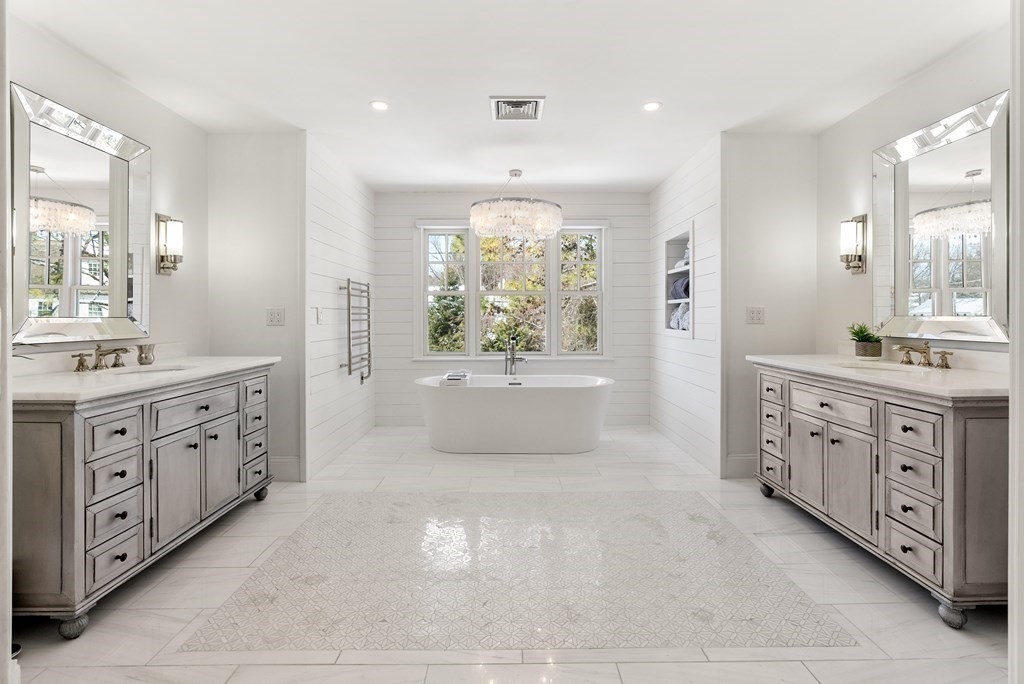 178 Lowell Road Wellesley, MA 02481 - Photo 23 of 38 a spacious bathroom with a double vanity sink a mirror a bathtub and window