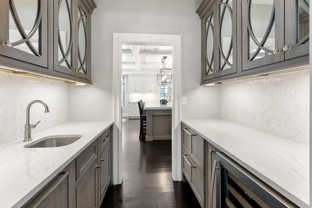 178 Lowell Road Wellesley, MA 02481 - Photo 10 of 38 a kitchen with stainless steel appliances granite countertop a sink and dishwasher a stove top oven with wooden floor