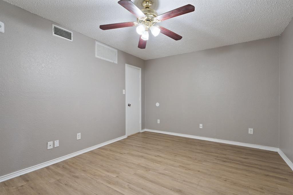 9831 Walnut Street, Unit 205 Dallas, TX 75243 - Photo 17 of 29 Spare room featuring a textured ceiling, light hardwood / wood-style floors, and ceiling fan