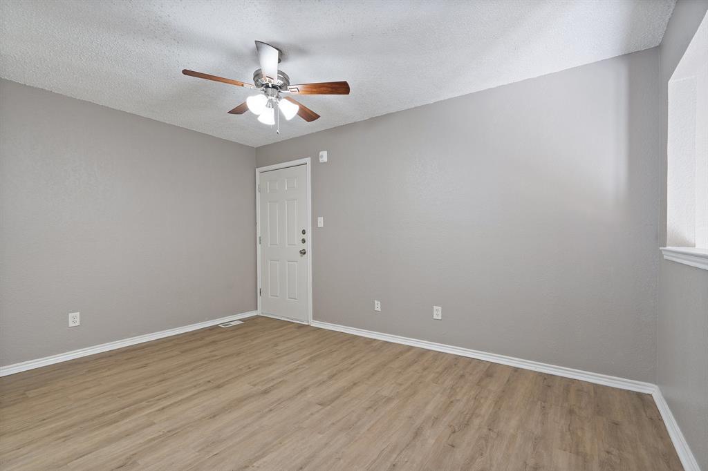9831 Walnut Street, Unit 205 Dallas, TX 75243 - Photo 21 of 29 Unfurnished room with ceiling fan, light hardwood / wood-style flooring, and a textured ceiling
