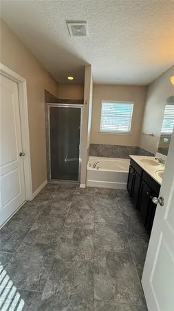 a view of a hallway to room with stairs and furniture