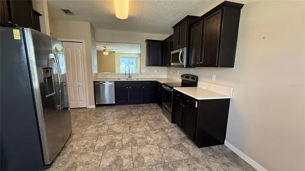 a kitchen with stainless steel appliances granite countertop a refrigerator and a sink