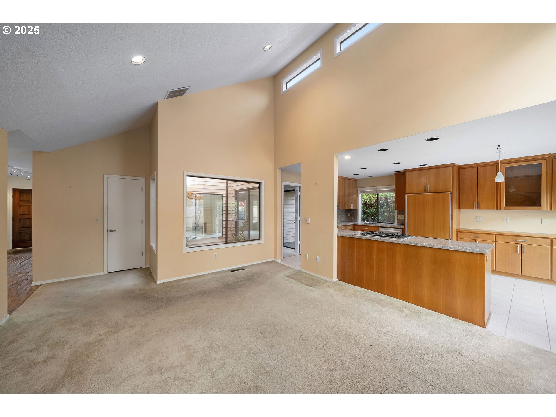 7104 Southwest Chapel Lane Portland, OR 97223 - Photo 16 of 36 a view of an empty room with kitchen and window
