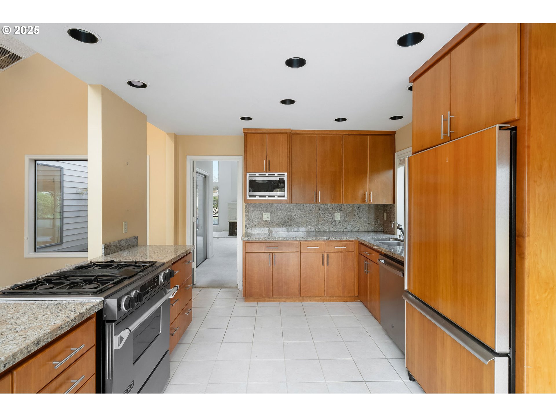 7104 Southwest Chapel Lane Portland, OR 97223 - Photo 18 of 36 a kitchen with stainless steel appliances granite countertop a stove a refrigerator and a refrigerator
