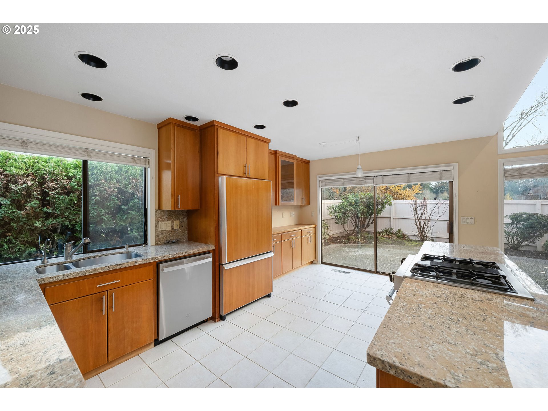 7104 Southwest Chapel Lane Portland, OR 97223 - Photo 20 of 36 a kitchen with stainless steel appliances granite countertop a refrigerator and a stove