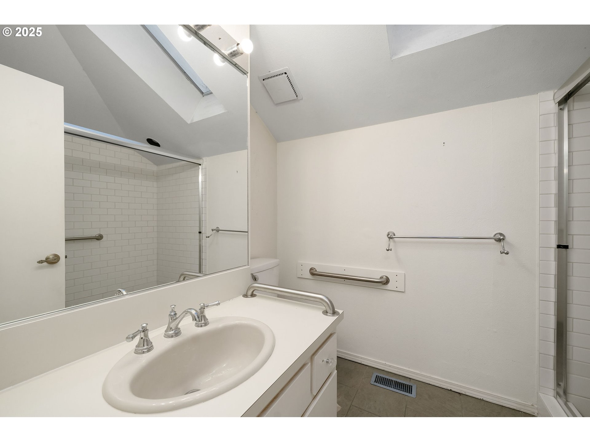 7104 Southwest Chapel Lane Portland, OR 97223 - Photo 24 of 36 a bathroom with a sink and a mirror