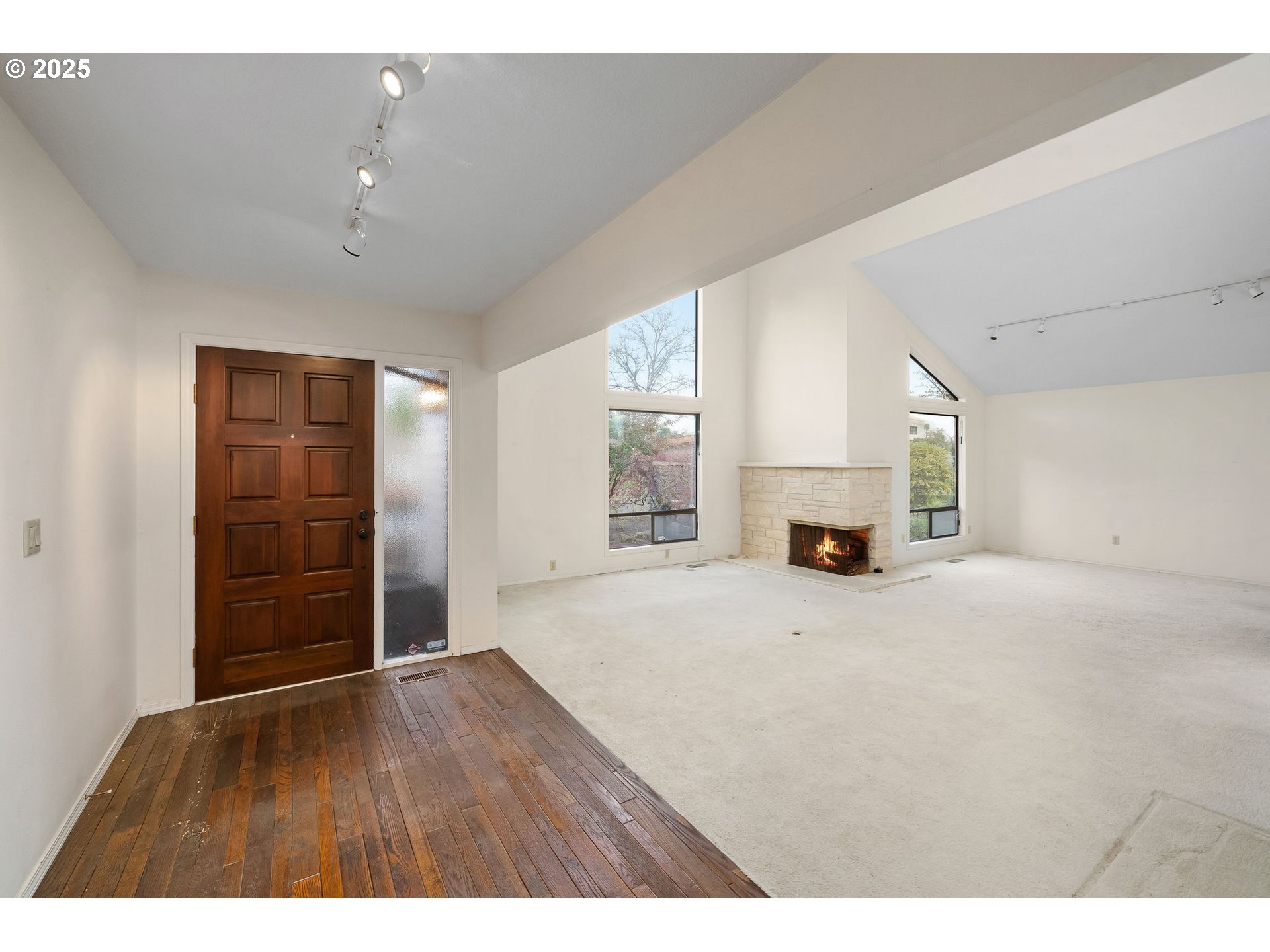 7104 Southwest Chapel Lane Portland, OR 97223 - Photo 6 of 36 a view of empty room with fireplace and wooden floor