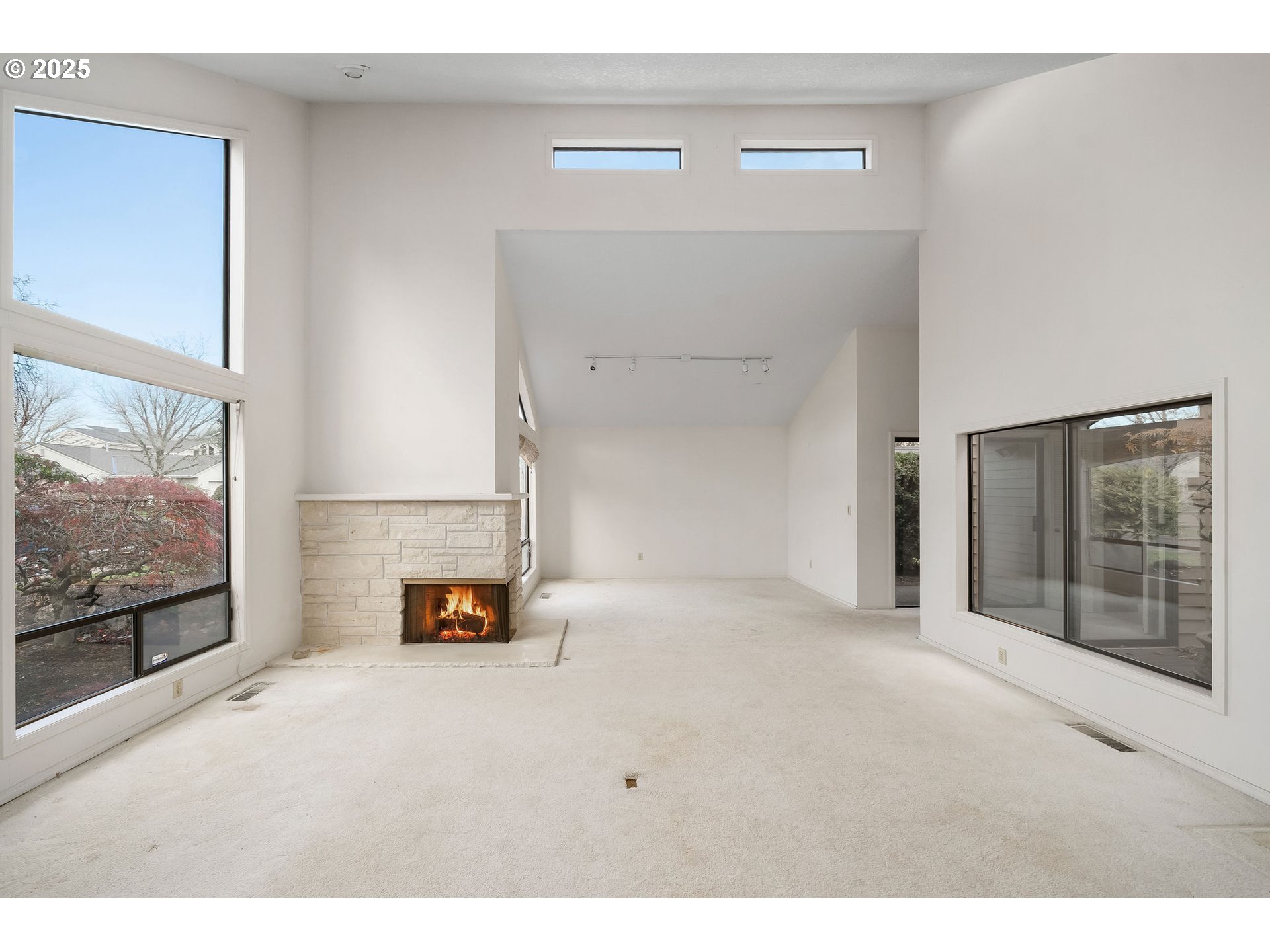7104 Southwest Chapel Lane Portland, OR 97223 - Photo 7 of 36 a view of an empty room with wooden floor and a window