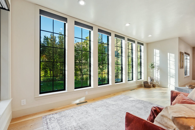 1141 South Oak Leaf Lane Springville, UT 84663 - Photo 56 of 147 Interior space featuring a bank of tall, grid-patterned windows with dark frames, light-colored walls, recessed lighting, light wood-finish flooring, and white baseboards