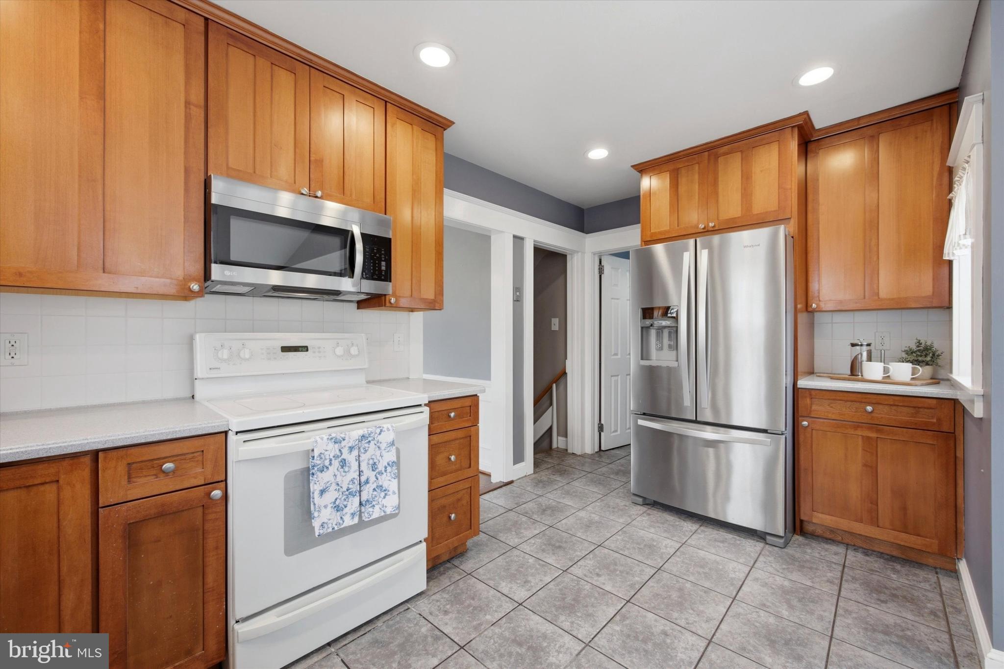 436 Kerr Lane Springfield, PA 19064 - Photo 12 of 52 a kitchen with stainless steel appliances granite countertop a refrigerator stove and microwave