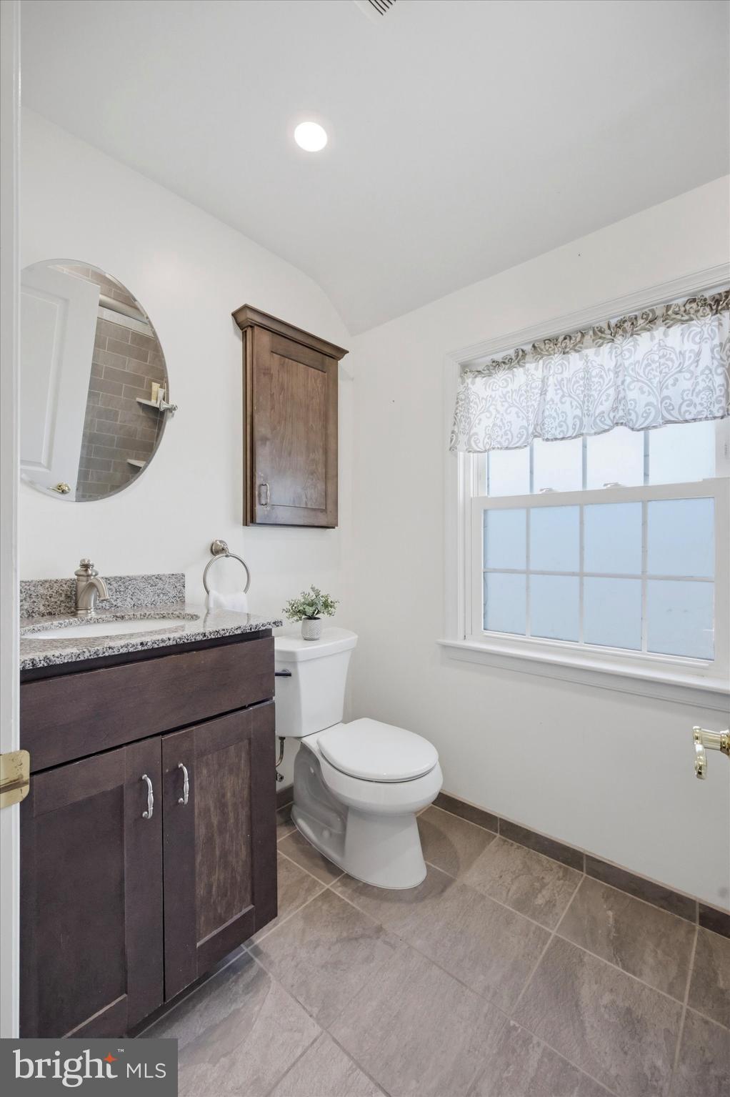 436 Kerr Lane Springfield, PA 19064 - Photo 23 of 52 a bathroom with a granite countertop toilet a sink and mirror