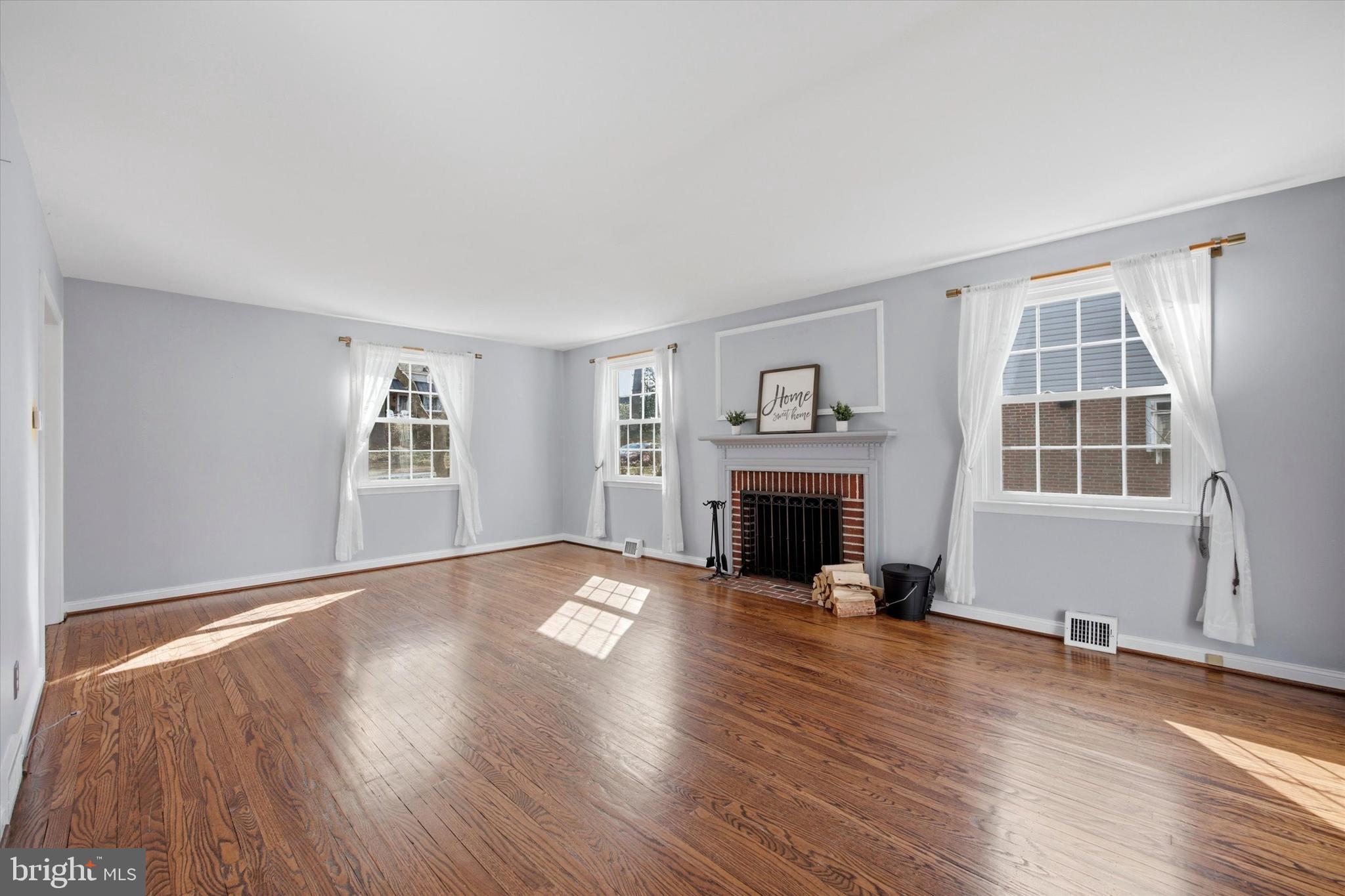 436 Kerr Lane Springfield, PA 19064 - Photo 7 of 52 an empty room with windows fireplace and windows