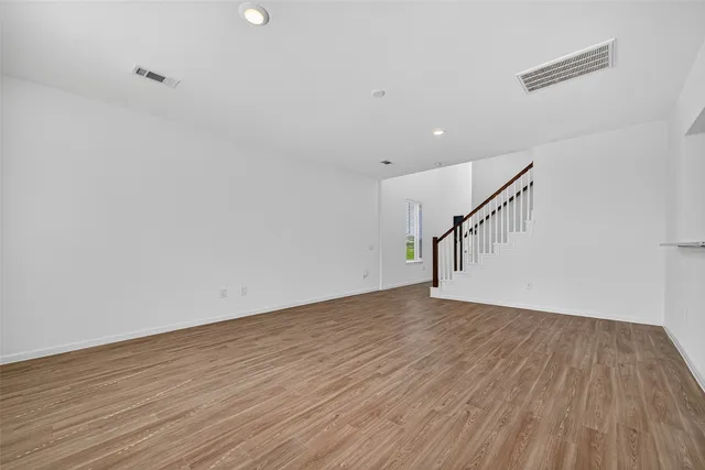 a view of room with wooden floor