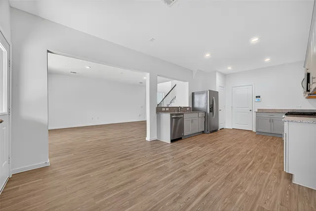a view of kitchen with wooden floor and electronic appliances