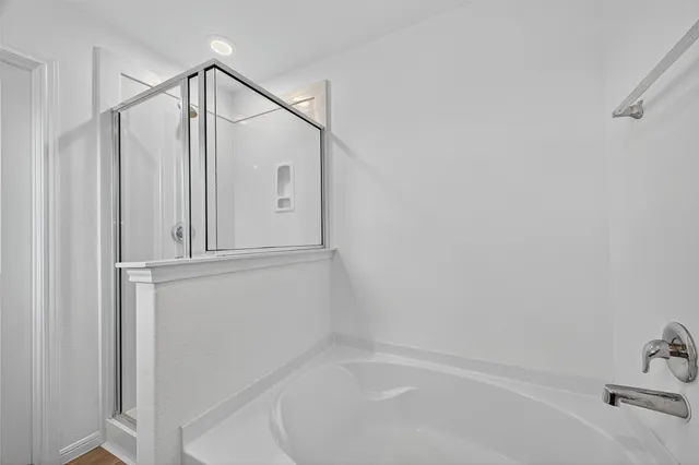 a bathroom with a bathtub and a shower