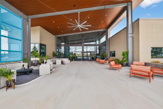 a lobby with furniture and potted plants