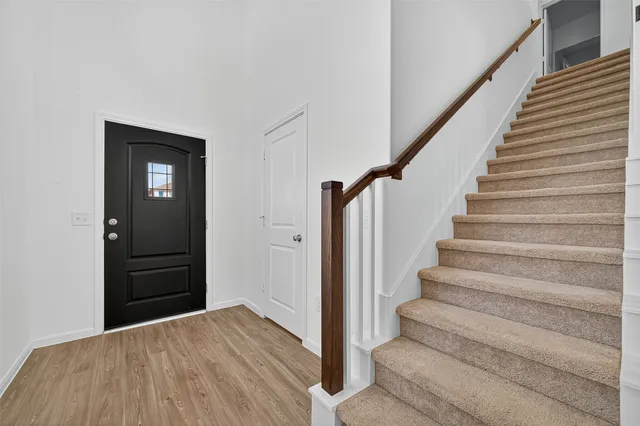 a view of an entryway with wooden floor
