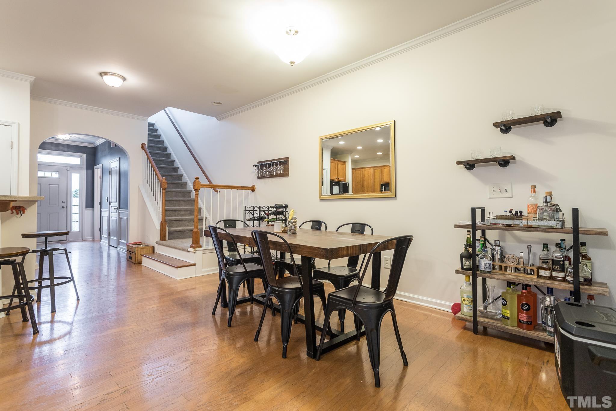 5050 Amber Clay Lane Raleigh, NC 27612 - Photo 11 of 23 a view of a dining room with furniture and wooden floor