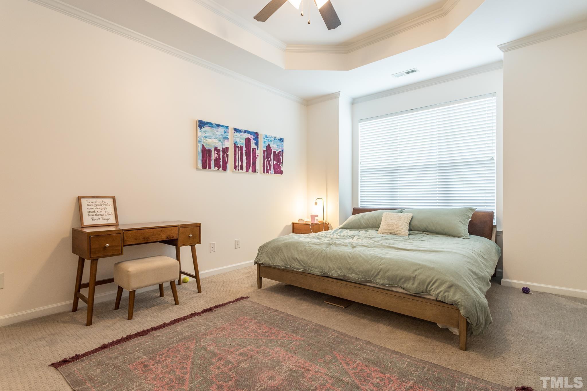 5050 Amber Clay Lane Raleigh, NC 27612 - Photo 14 of 23 a bedroom with a bed and a chair
