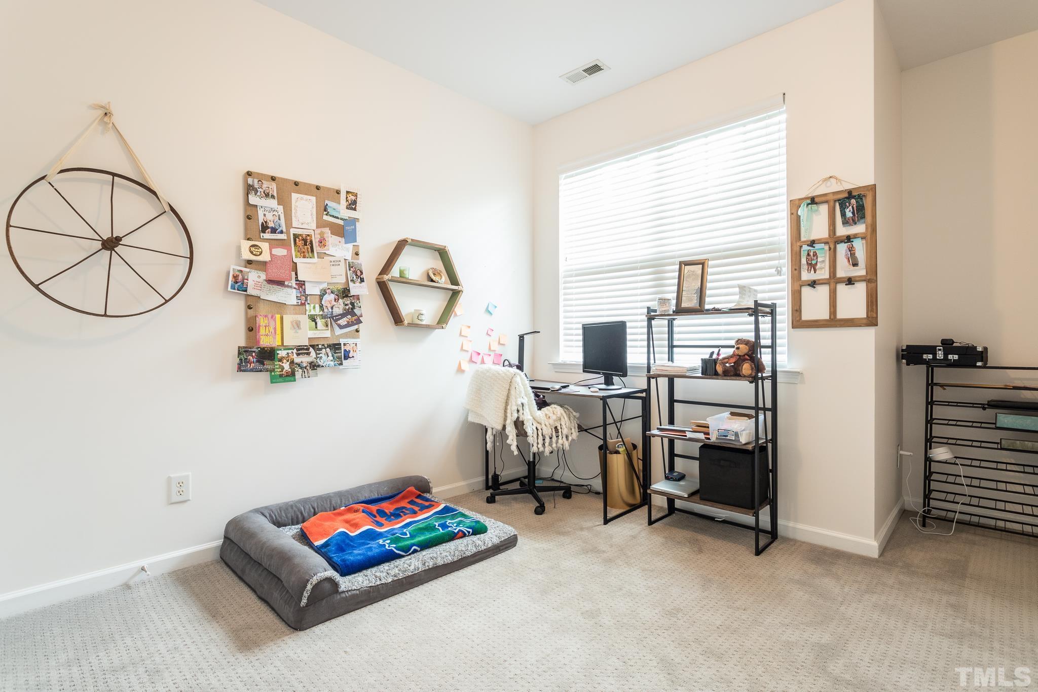 5050 Amber Clay Lane Raleigh, NC 27612 - Photo 19 of 23 a living room with furniture a rug and white walls