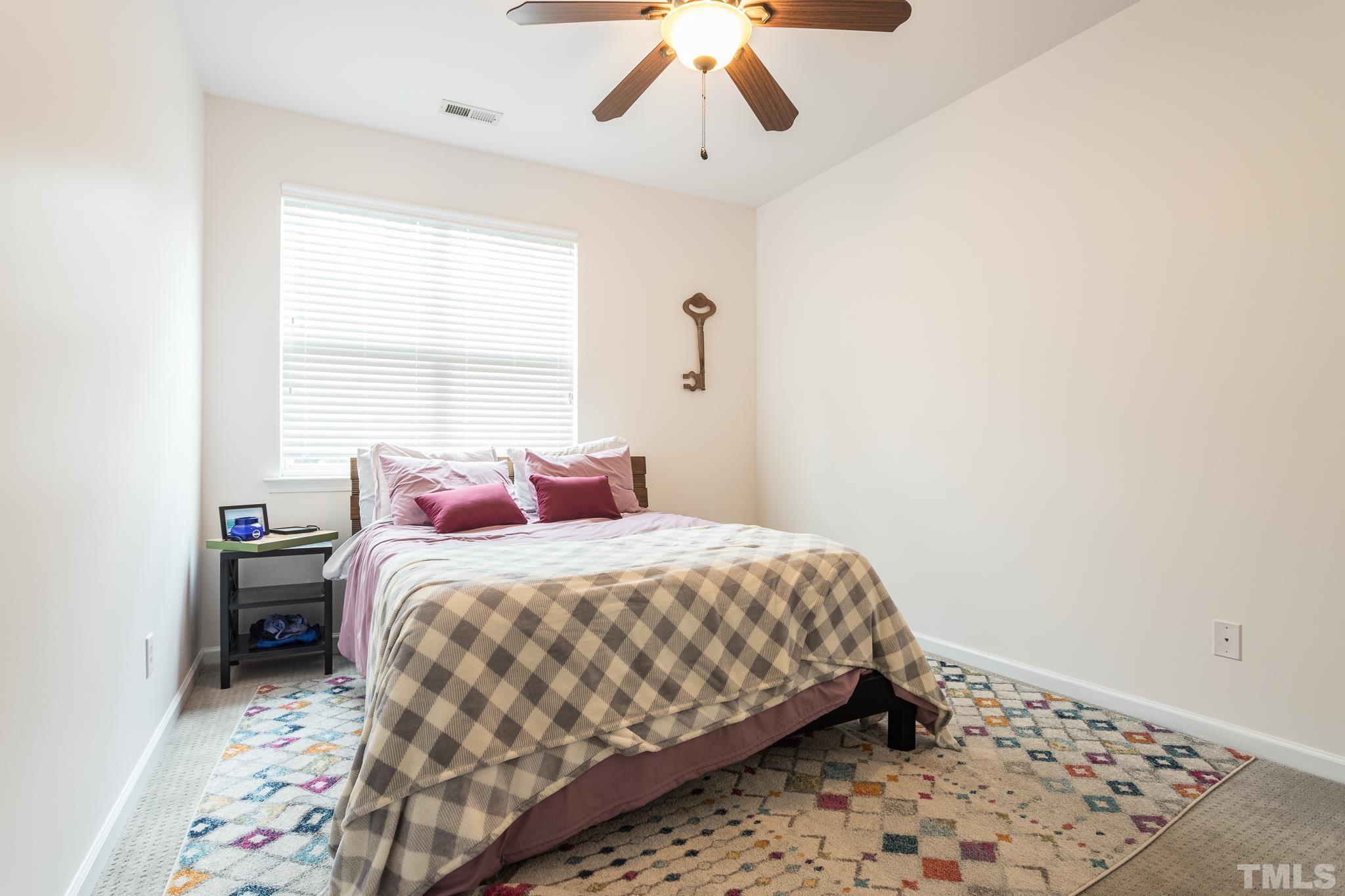 5050 Amber Clay Lane Raleigh, NC 27612 - Photo 21 of 23 a bedroom with a bed and a window
