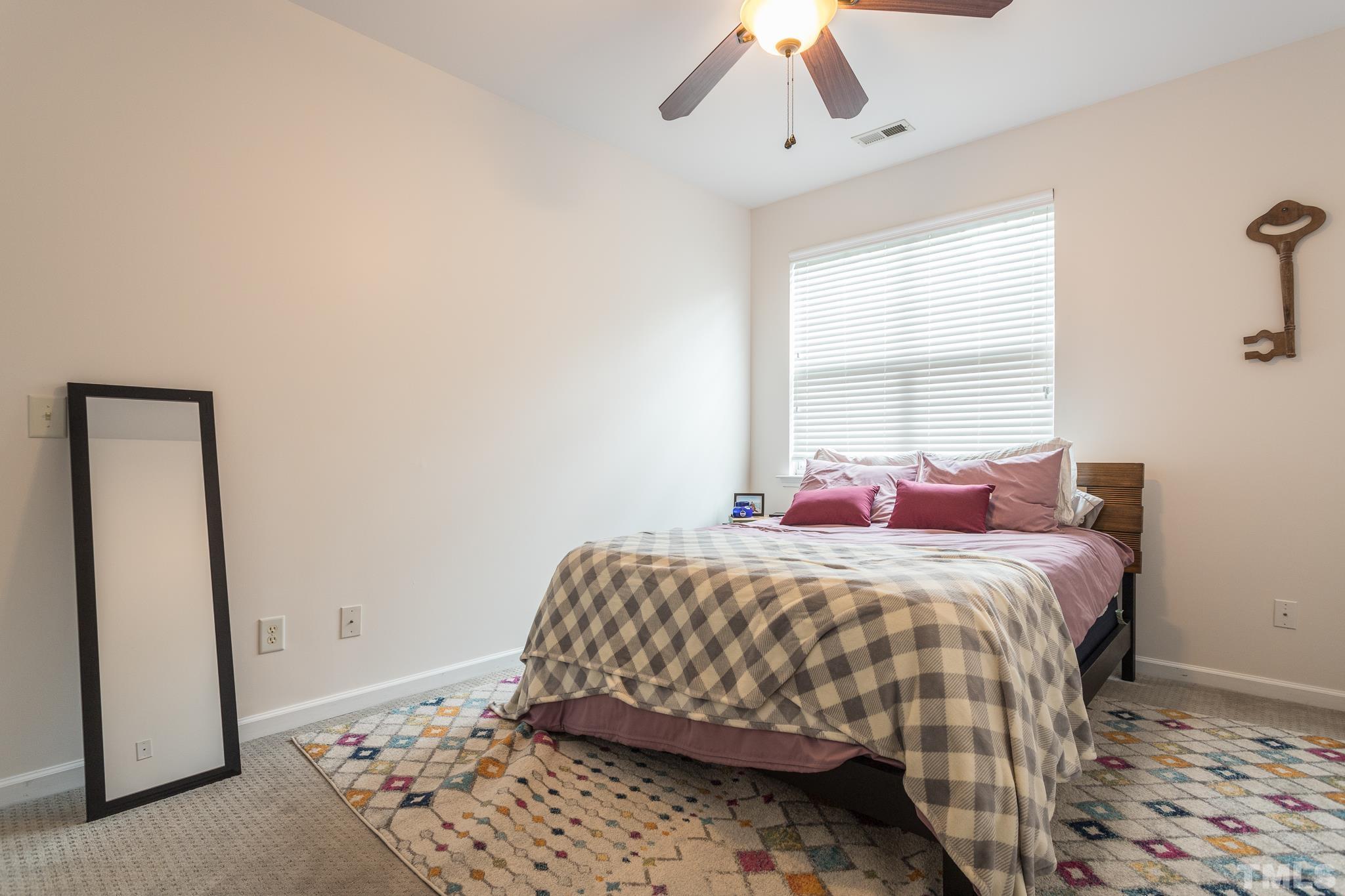5050 Amber Clay Lane Raleigh, NC 27612 - Photo 22 of 23 a bedroom with a bed and a window