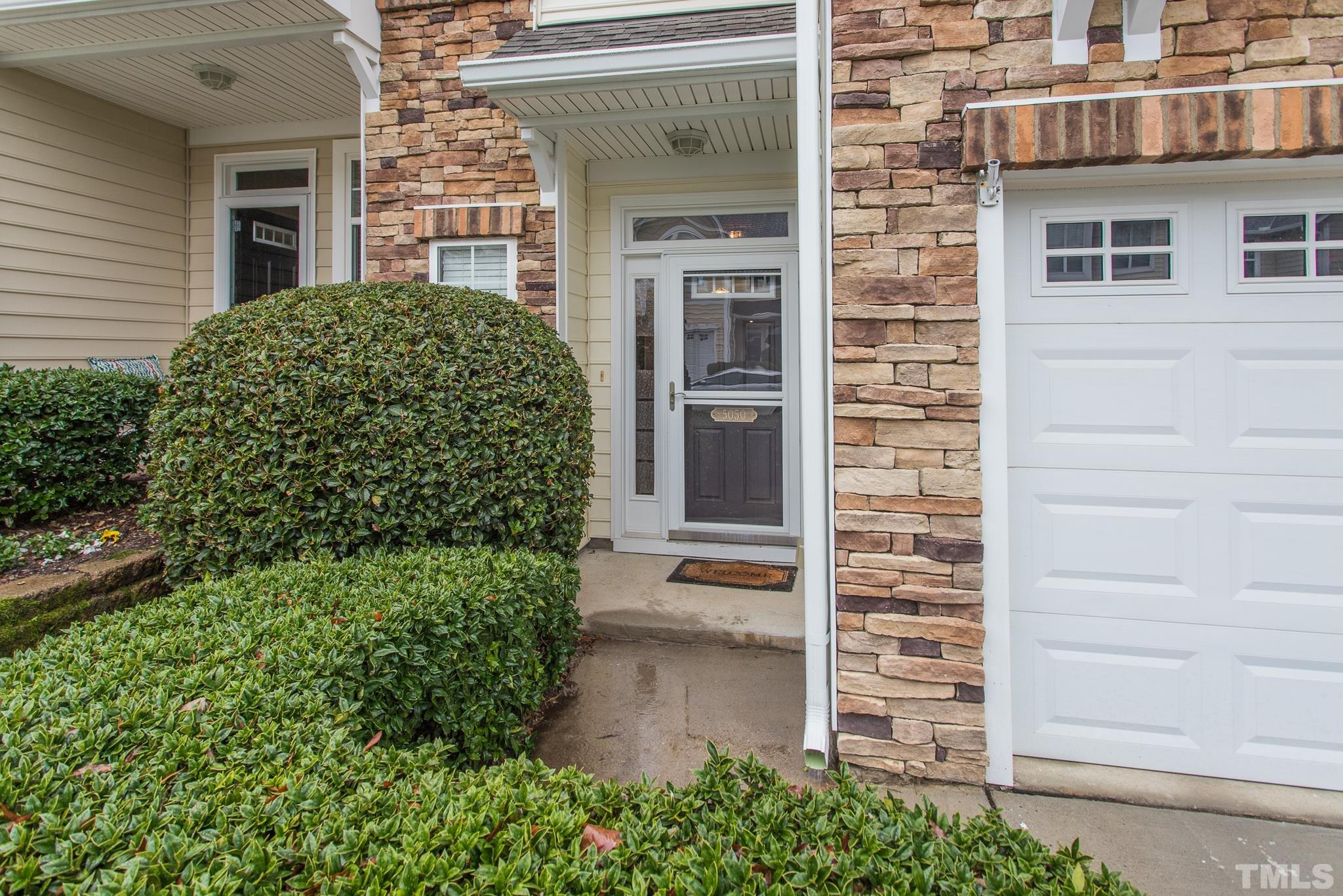 5050 Amber Clay Lane Raleigh, NC 27612 - Photo 4 of 23 a view of a brick house with a large windows