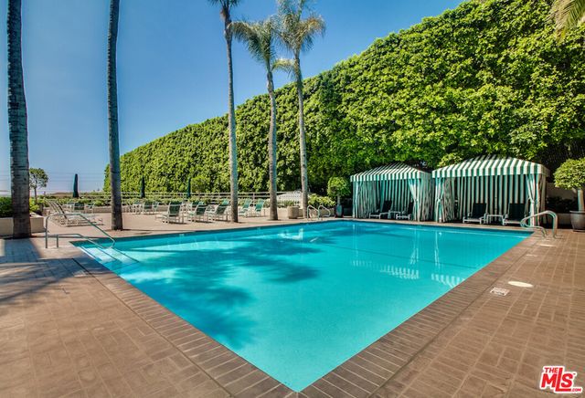 a view of a house with a backyard patio and swimming pool