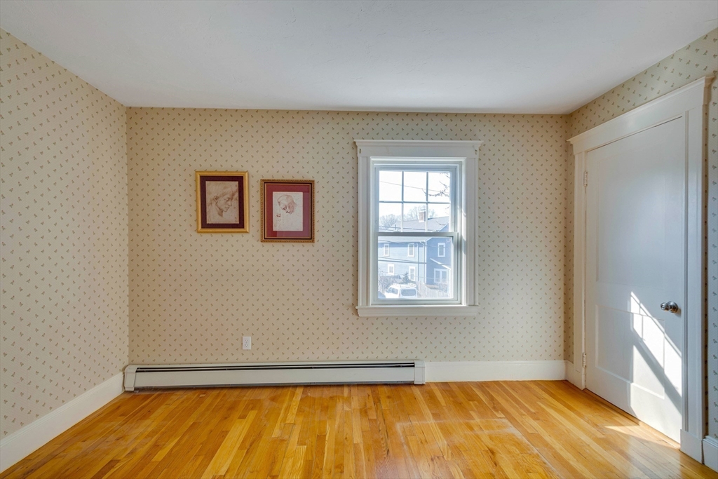 32 Emerson Road Needham, MA 02492 - Photo 15 of 27 a view of an empty room with wooden floor and a window