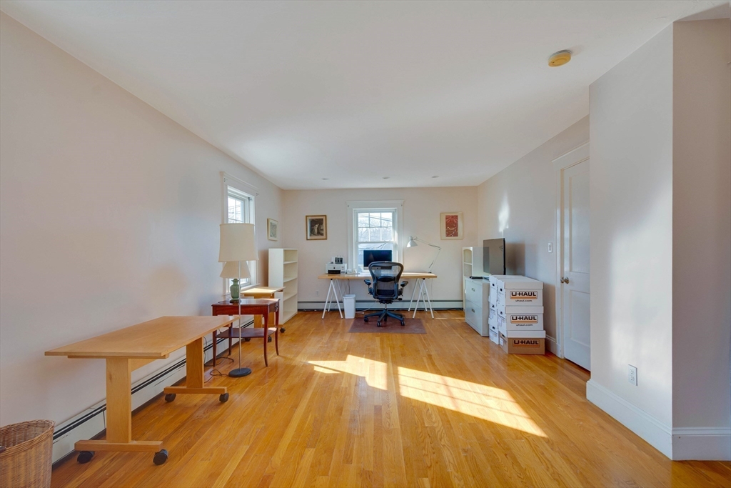 32 Emerson Road Needham, MA 02492 - Photo 17 of 27 a living room with furniture and a table