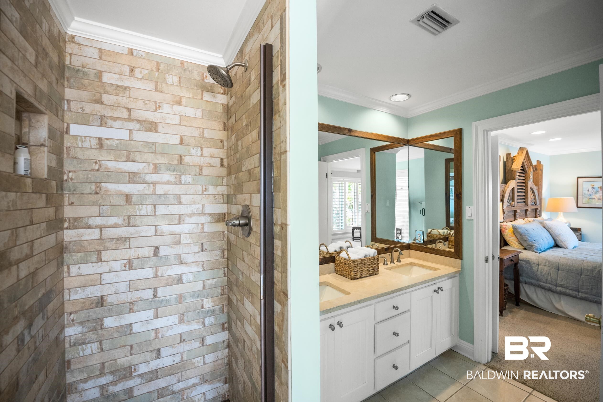 31304 River Road Orange Beach, AL 36561 - Photo 27 of 78 Ensuite bathroom featuring visible vents, ensuite bathroom, a sink, ornamental molding, and a stall shower