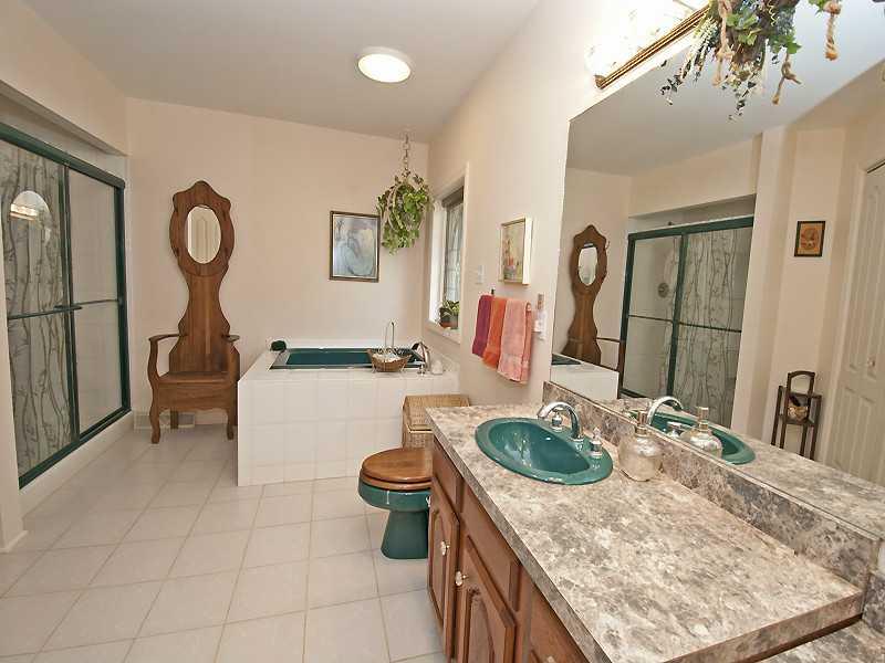 68 Fulton Road Canonsburg, PA 15317 - Photo 14 of 20 Master Bath/Spa. Ceramic, Chestnut cabinets, and custom Pella Stained glass window overlooking the Jacuzzi tub.